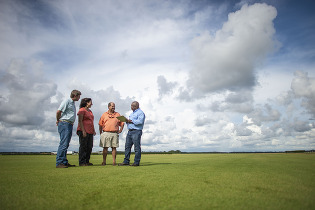 people talking in field 