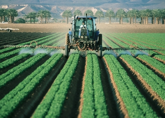farmer sprays crops in tracker