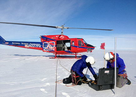 Lynn Kaluzienski, from the University of Maine, and mountaineer Peter Braddock placing GPS equipment in the Antarctic shear zone.
