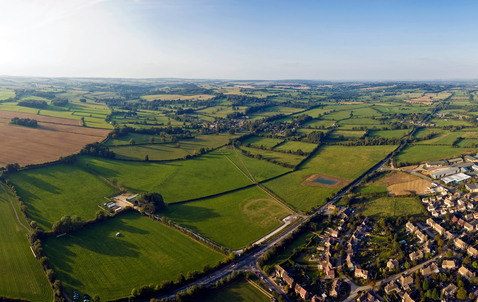 Aerial vista, village, and field. Image by GettyImages