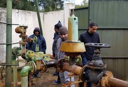 Dr. Ali Mirchi (center) with Tunisian colleagues visiting a groundwater well outside Tunis, Tunisia.