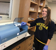 Bay Mills Community College student Alyssa McGlinch is placing her sample in the Direct Mercury Analyzer. 