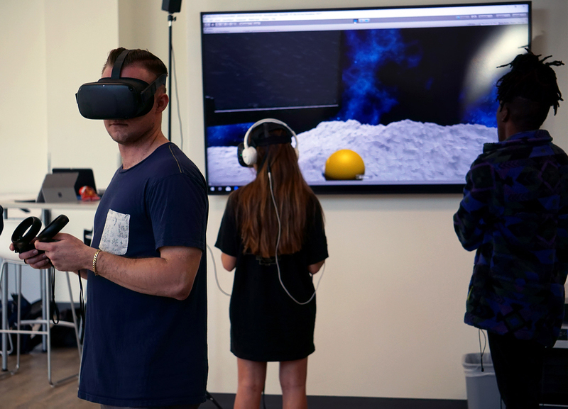 Tech Core coder Tim Lukau (right) stands by as two students simultaneously explore the Nano 2020 environment. Image courtesy of University of Arizona.