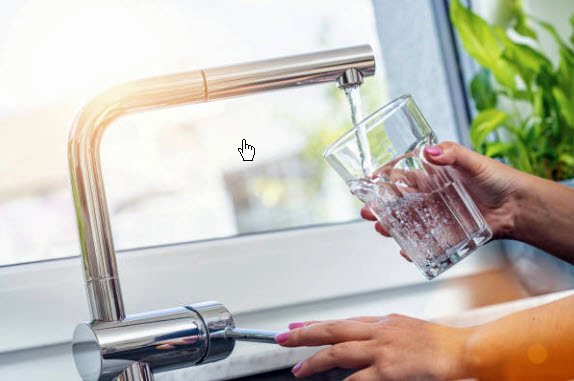 Woman filling a glass of water. Photo Courtesy of Getty Images.