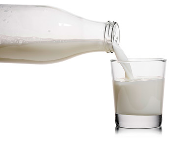 Pouring milk into a glass. Photo courtesy of Getty Images.