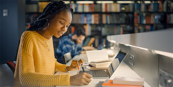 Funding Opportunity for the 1890 CBG Program. Image of girl studying in a library; courtesy of Adobe Stock.