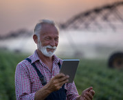 Farmer with tablet checking his irrigation system. Photo courtesy of Getty Images.