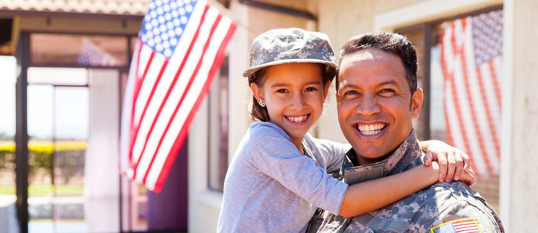 U.S. Army soldier and daughter. Image courtesy of Getty Images.