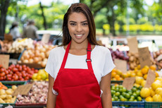 Selling fruits and vegetables at a farmers’ market, courtesy of Adobe Stock.