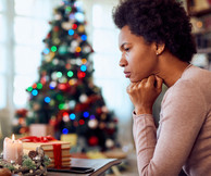 Worried woman thinks of the holidays, courtesy of Adobe Stock.