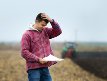 Worried young farmer, courtesy of Getty Images.