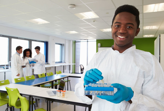 A student in a lab coat.