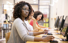 Funding Opportunity for the CBG program. College student studying on a computer courtesy of Adobe Stock