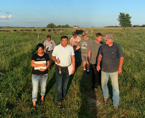 Latino farmers learning grass management practices, courtesy of Lincoln University Cooperative Extension.