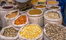 Bags of dried legumes and grains in a market, courtesy of Adobe Stock.