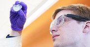 Purdue researcher holds vials of nanocarrier treatments. Image courtesy of Purdue University