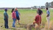 Clemson researchers discuss the field design for growing cover crops. Image courtesy of Clemson University
