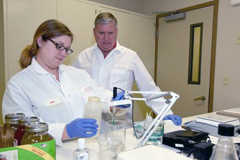 Tollett Lab Director Randy Moore, DVM, and microbiologist Amy Chapman analyze samples. Credit University of Arkansas System Division of Agriculture.