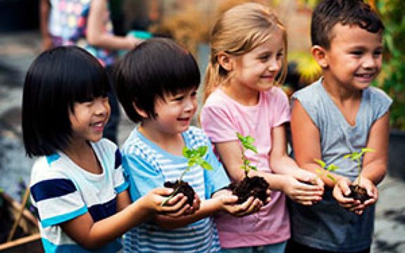 Children Holding Plants, courtesy of Adobe Stock.