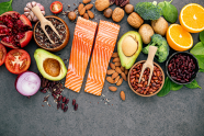 Fresh vegetables, fruits, nuts and salmon.  Image courtesy of Adobe Stock.
