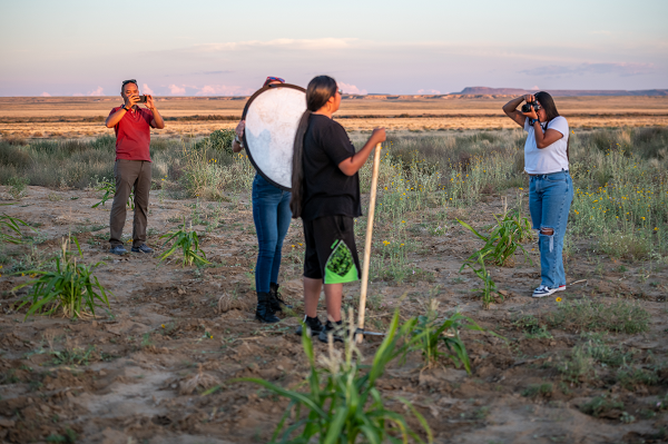 Hopi Tribe Cooperative Extension and 4-H Hopi Healthy Living program youth working on photography in a corn field. 