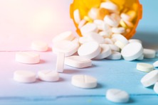 Prescription drugs scattered on table. Image courtesy of Adobe Stock.