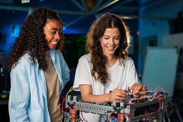 Young women in robotics lab. Image courtesy of Adobe Stock.