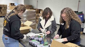 University of Idaho Extension educators label ground beef packages. Image courtesy of University of Idaho.