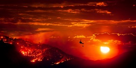 Wildfire burning at sunset. Image courtesy of Adobe Stock.