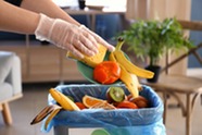 Food being put in garbage. Image courtesy of Adobe Stock.