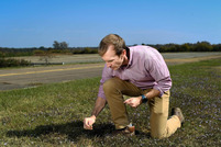Jay McCurdy examines plants in a refuge lawn. Image courtesy of Grace Cockrell, Mississippi State University.