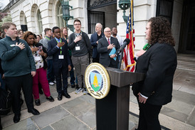 Youth delegate Kyra Fowler (Idaho) leads attendees in the pledge of allegiance in front of USDA headquarters. USDA photo.