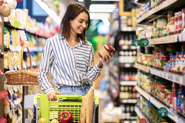  Woman looking at product label. Image courtesy of Adobe Stock.