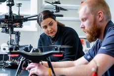 Faculty member and student discussing drones. USDA image.