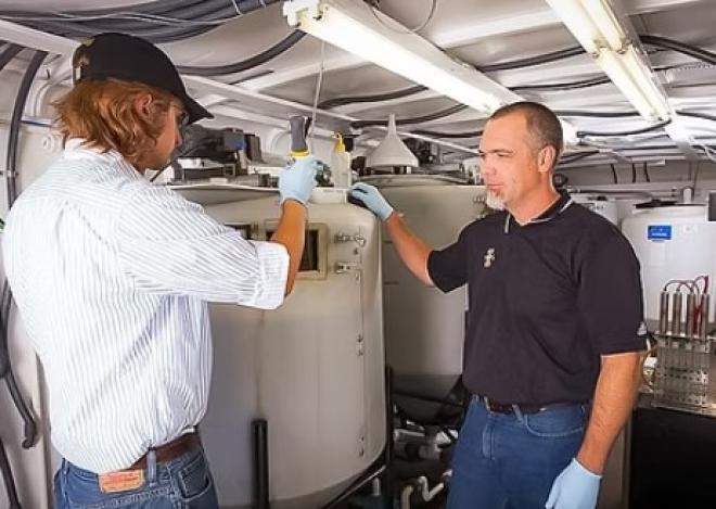 Researchers sample the fermenters where bacteria produce bioplastics. Image courtesy of University of Idaho.  