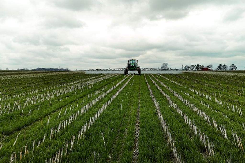 Farmer spraying a cover crop. Image courtesy of USDA.