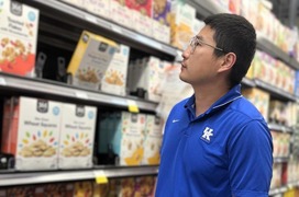 Shuoli Zhao looking at cereals in a local grocery store. Photo courtesy of University of Kentucky.