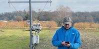 Len Coop, Oregon State University professor checks an insect predictive model driven by data collected by a weather station. 