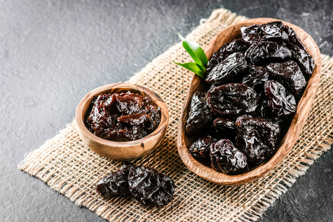 Small containers of prunes. Image courtesy of Adobe Stock.