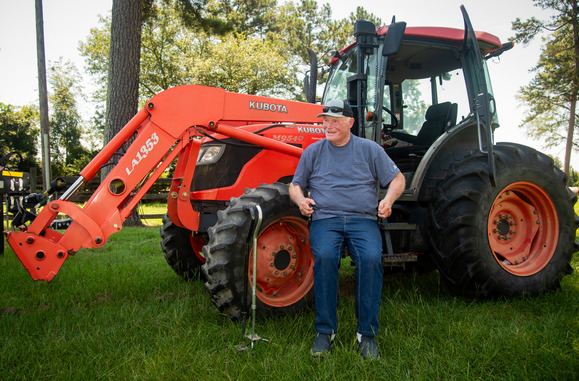 Donald Adams using a lift to reach the cab of his tractor. Image courtesy of University of Georgia.