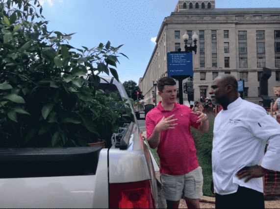 USDA David Matthews speaking with a farmers market visitor