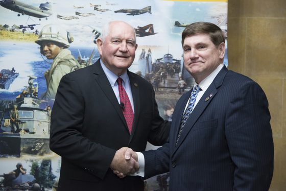 Secretary Perdue receives a Vietnam Veteran lapel pin from Larry Brom of the Vietnam War Commemoration