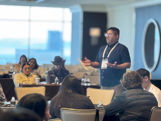 USDA Central Plans Tribal College Liaison Kellen Palmer presents to youth at the Intertribal Agriculture Council (IAC) conference in December 2024
