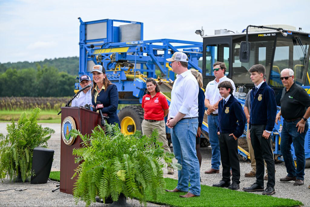 Secretary Rollins speaking at a podium