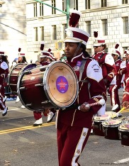 Black college student drumming in Macy's parade