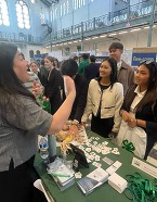 Asian American woman representing USDA talks with other Asian American women