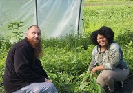 Veterans Tsiltiyah Fogle and her husband Charles Fogle sitting outside in a field