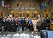 Large group of Hispanic educators standing in a large foyer