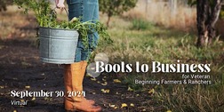 Photo of person from waist down wearing jeans and boots holding a bucket with carrot tops