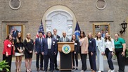 A group of mixed race college students standing in a row